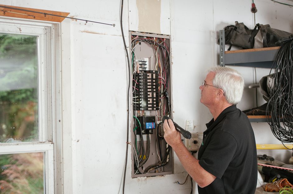 Electrician installing wiring on a job site