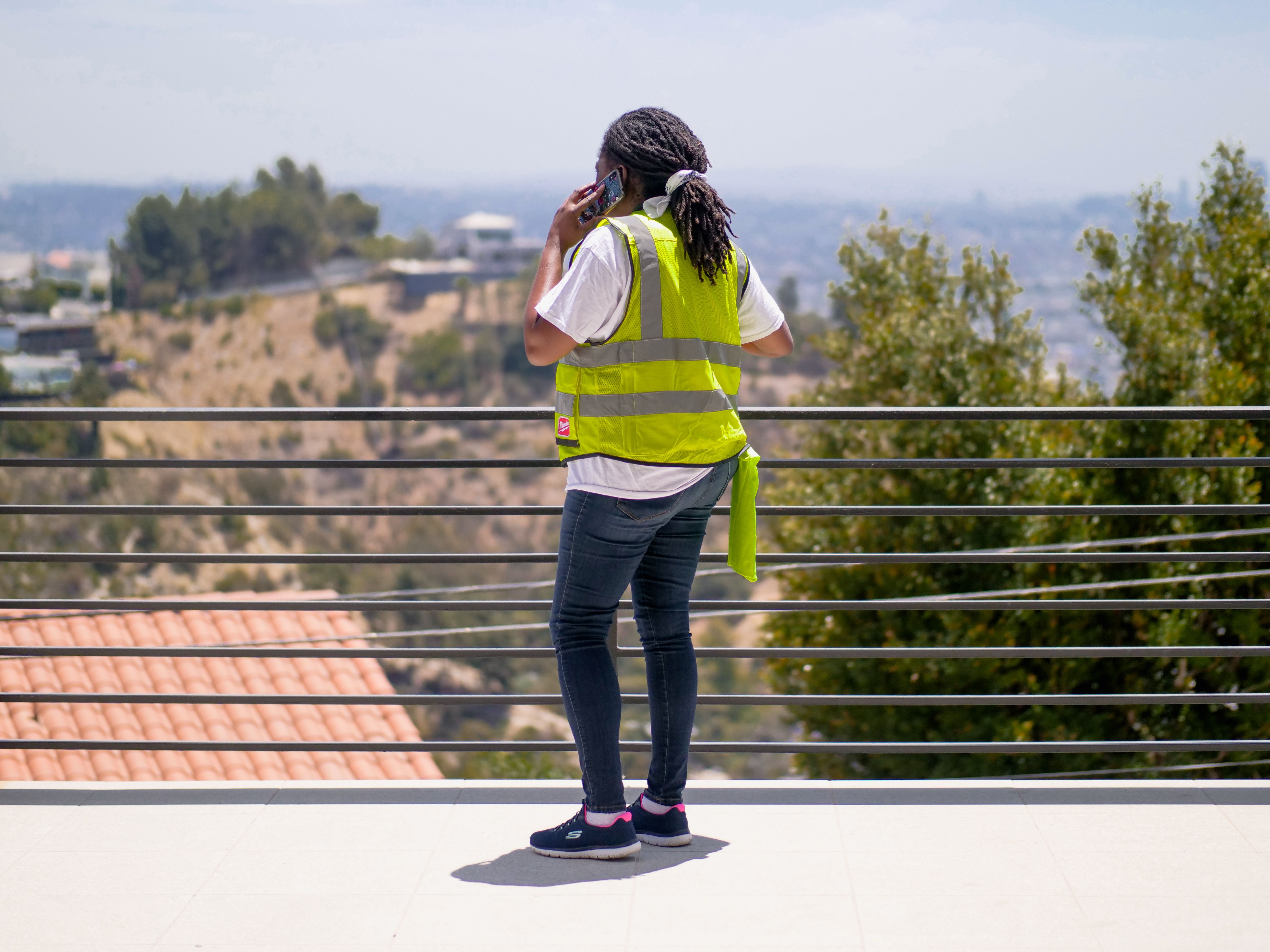 Home-service contractor taking a customer call on a job site